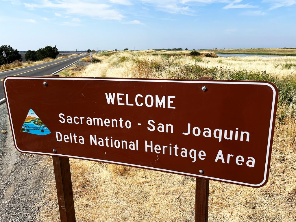 Roadside sign that says "WELCOME Sacramento - San Joaquin Delta National Heritage Area"