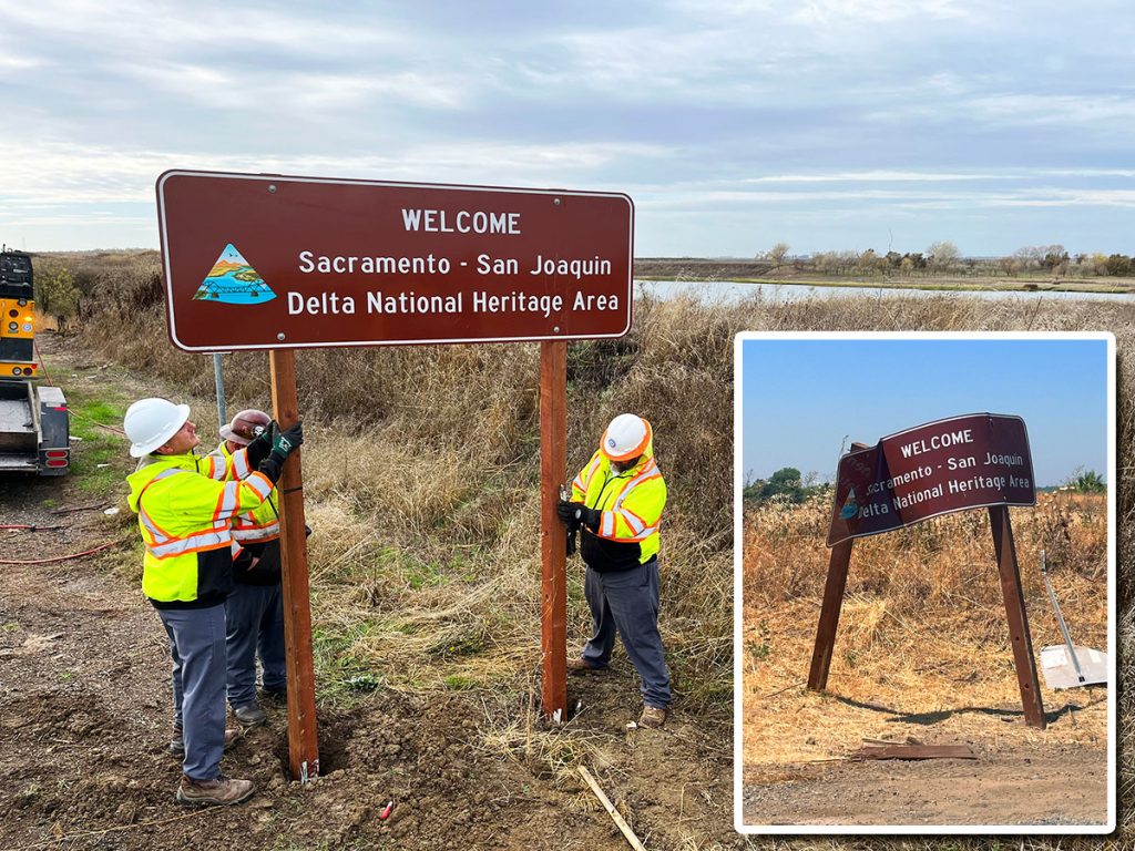 Workers install a sign welcoming motorists to the California Delta