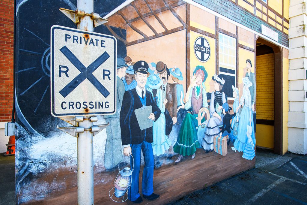 A mural of Victorian-era people waiting at a train station