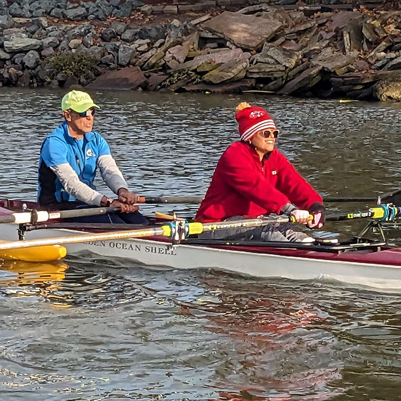 Woman and man rowing a scull boat