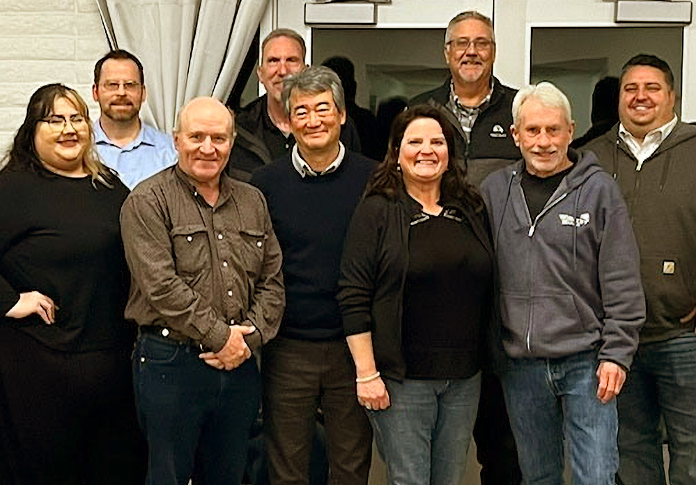 A group of adults poses for a group photo