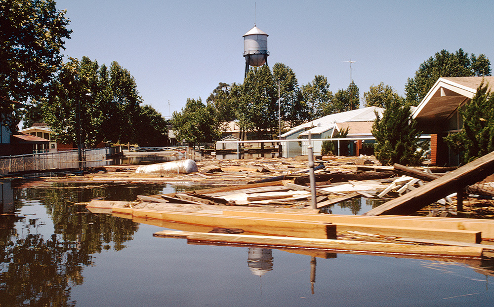 Debris piles up in a flooded town