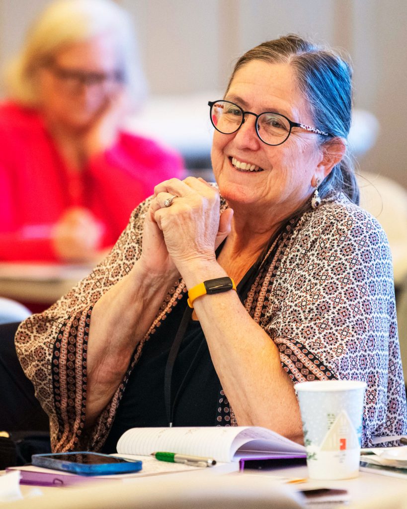 Woman smiling with hands clasped