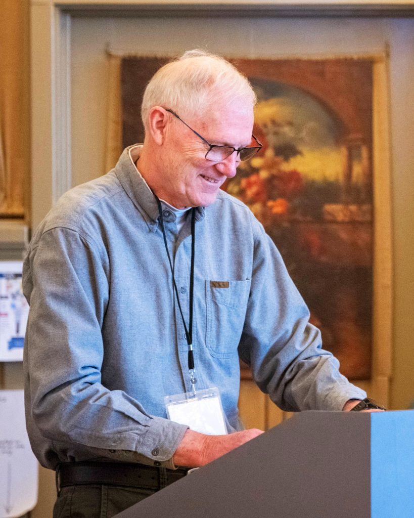 Man reading from notes at a podium