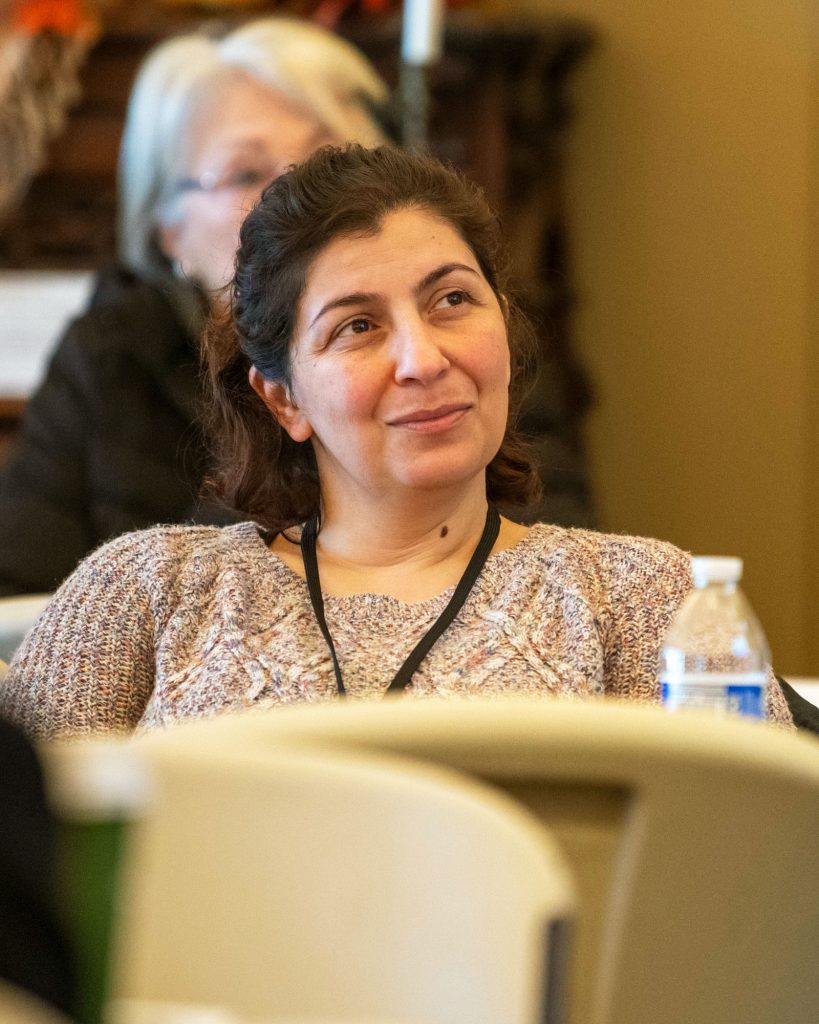 Woman looking with interest at a speaker