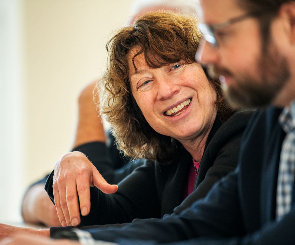 A woman smiles as she looks at a fellow panelist