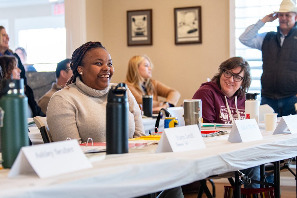 Woman at conference table laughing