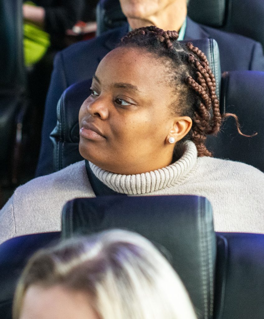 Woman on a bus gazing across the aisle