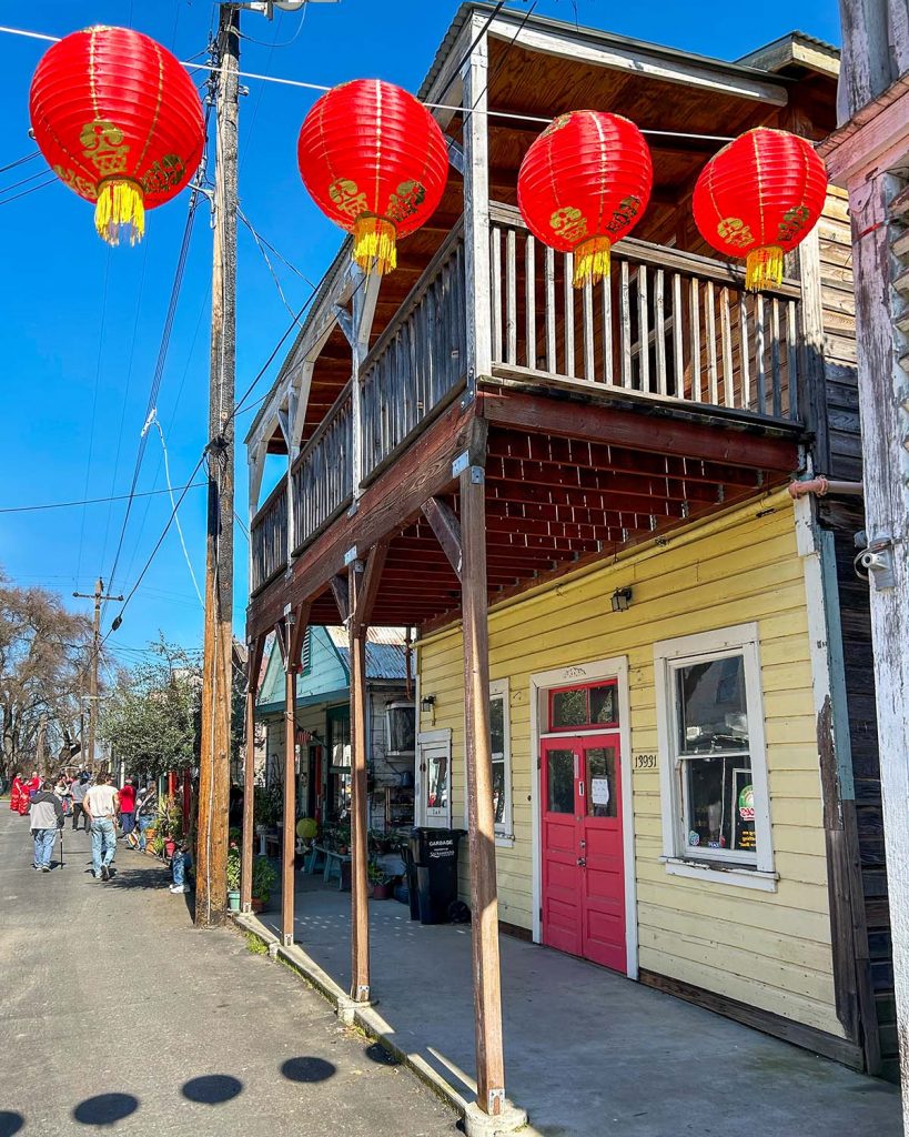 Red lanterns hanging across a street