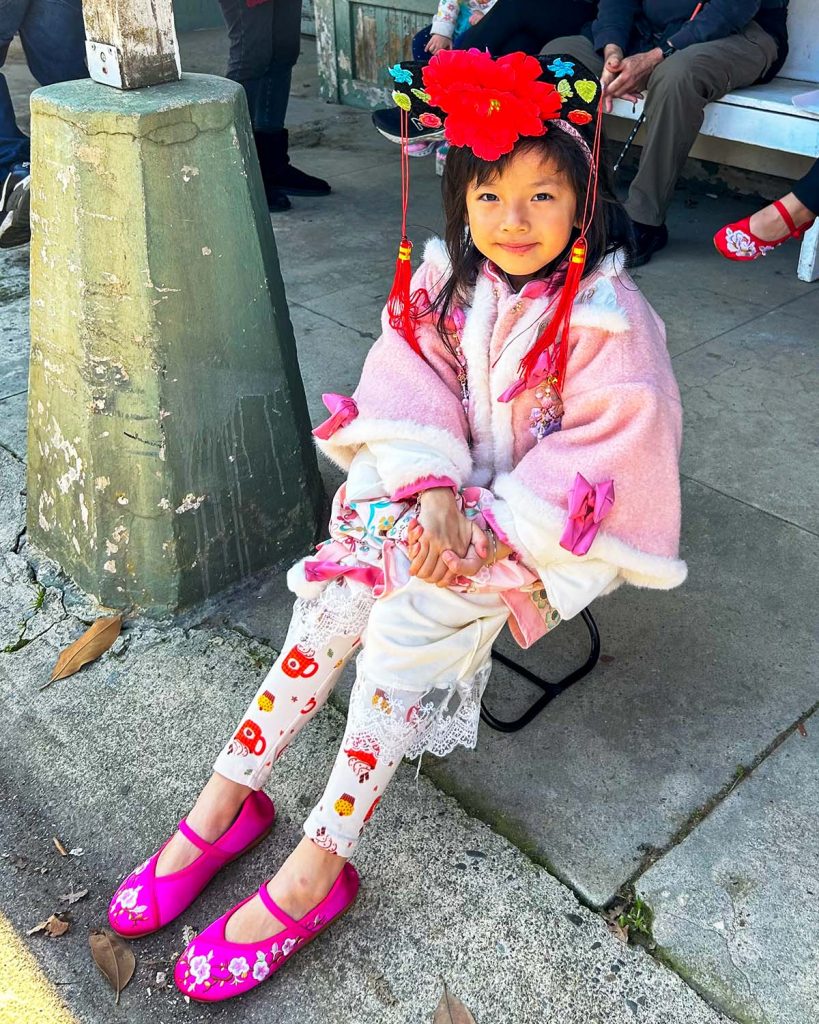 A young girl in pink and red traditional Chinese garb