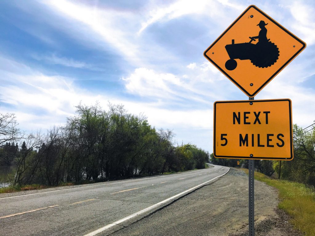 A sign advises motorists to expect farm equipment for the next five miles
