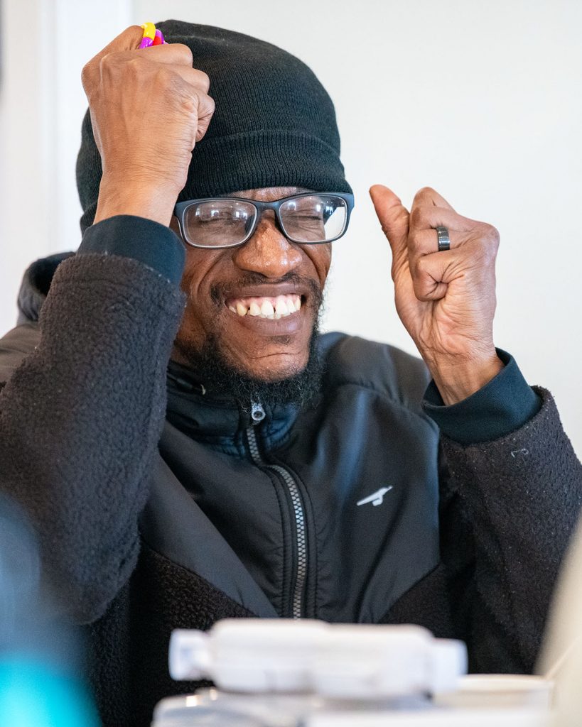 A man squints his eyes and clenches his fists in a show of frustration