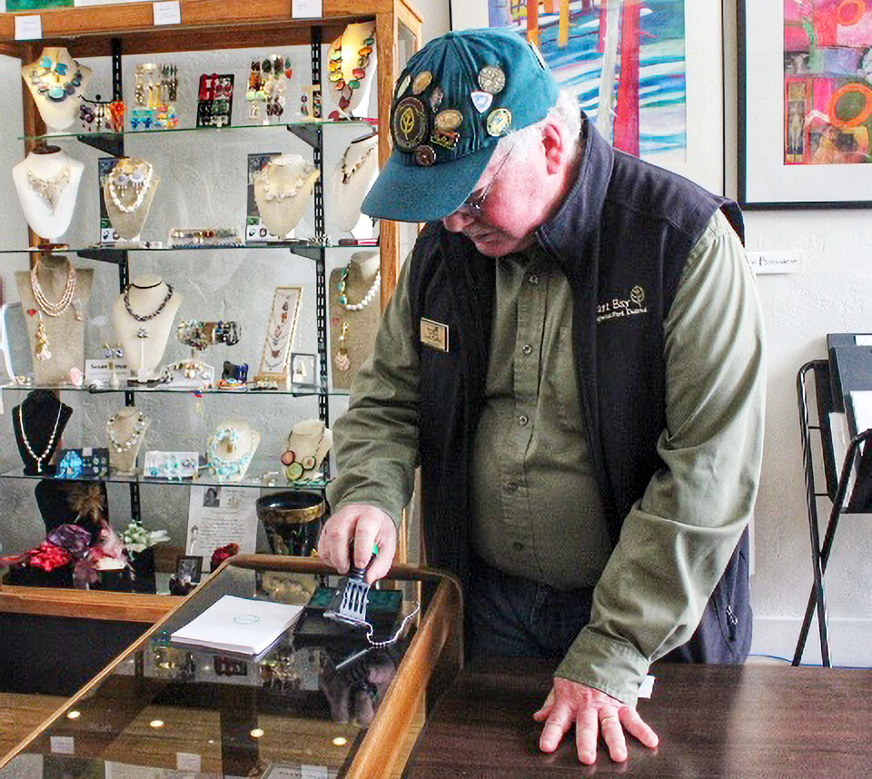 A man reaches for a rubber stamp