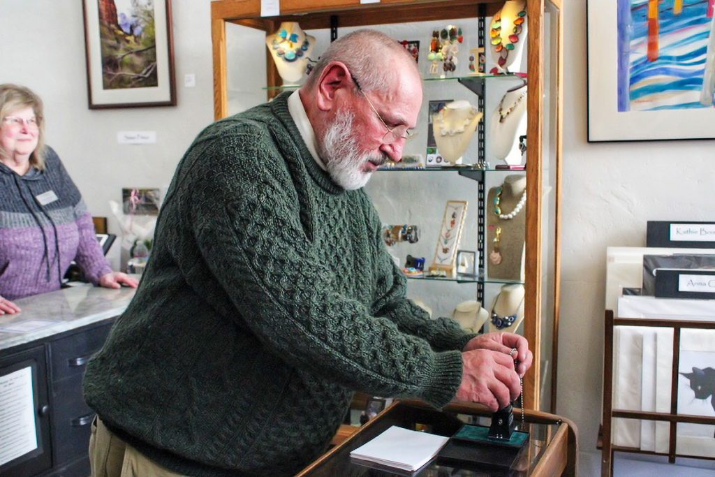 A man presses ink into a rubber stamp